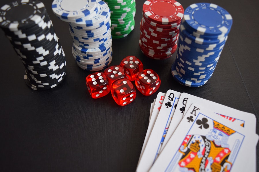 chips, dice, and cards on casino table